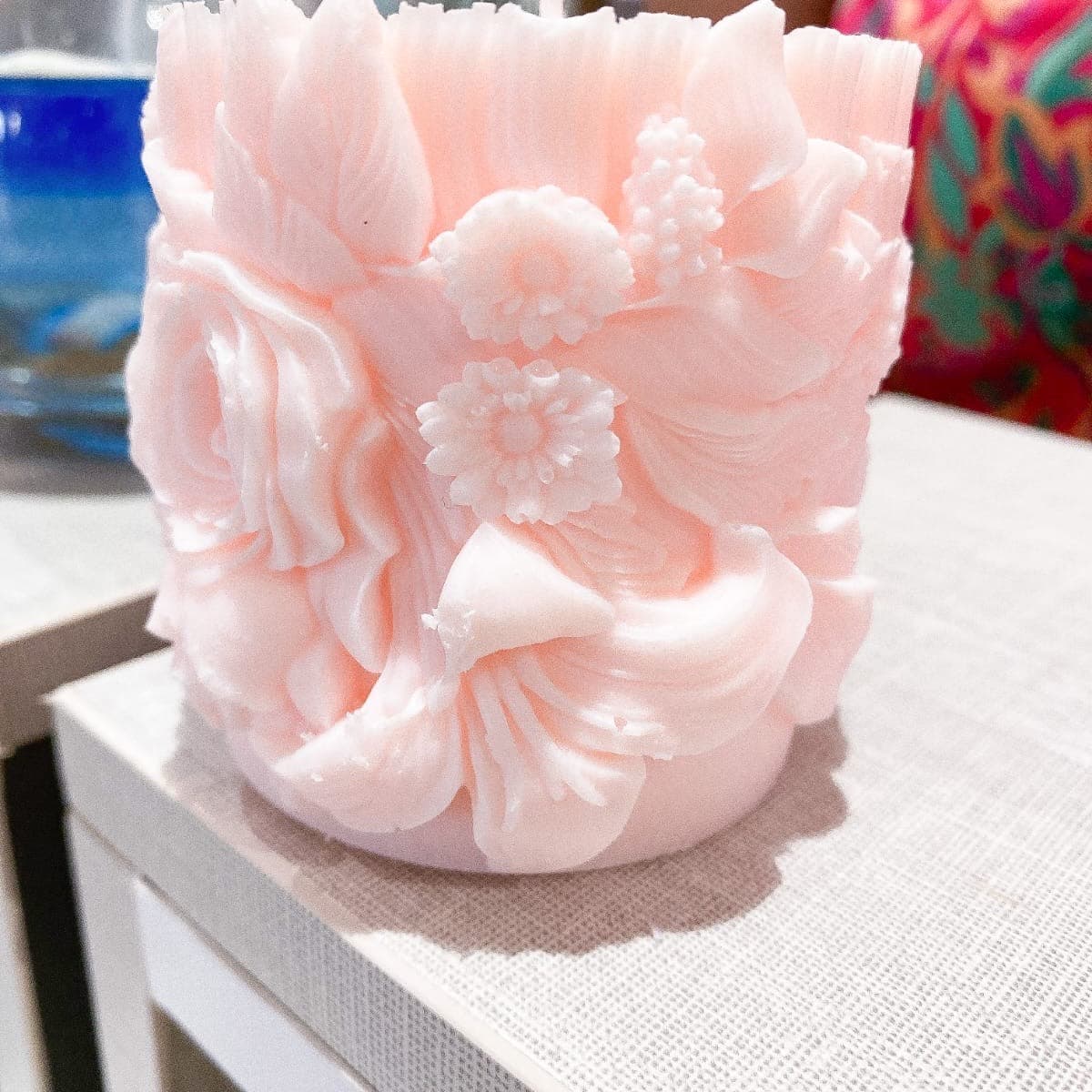 Soft pink pillar candle carved with roses, lilies and daisies