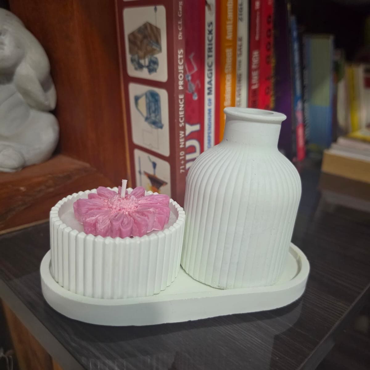 Pink dahlia candle in a fluted ceramic pot with matching bud vase and oval tray